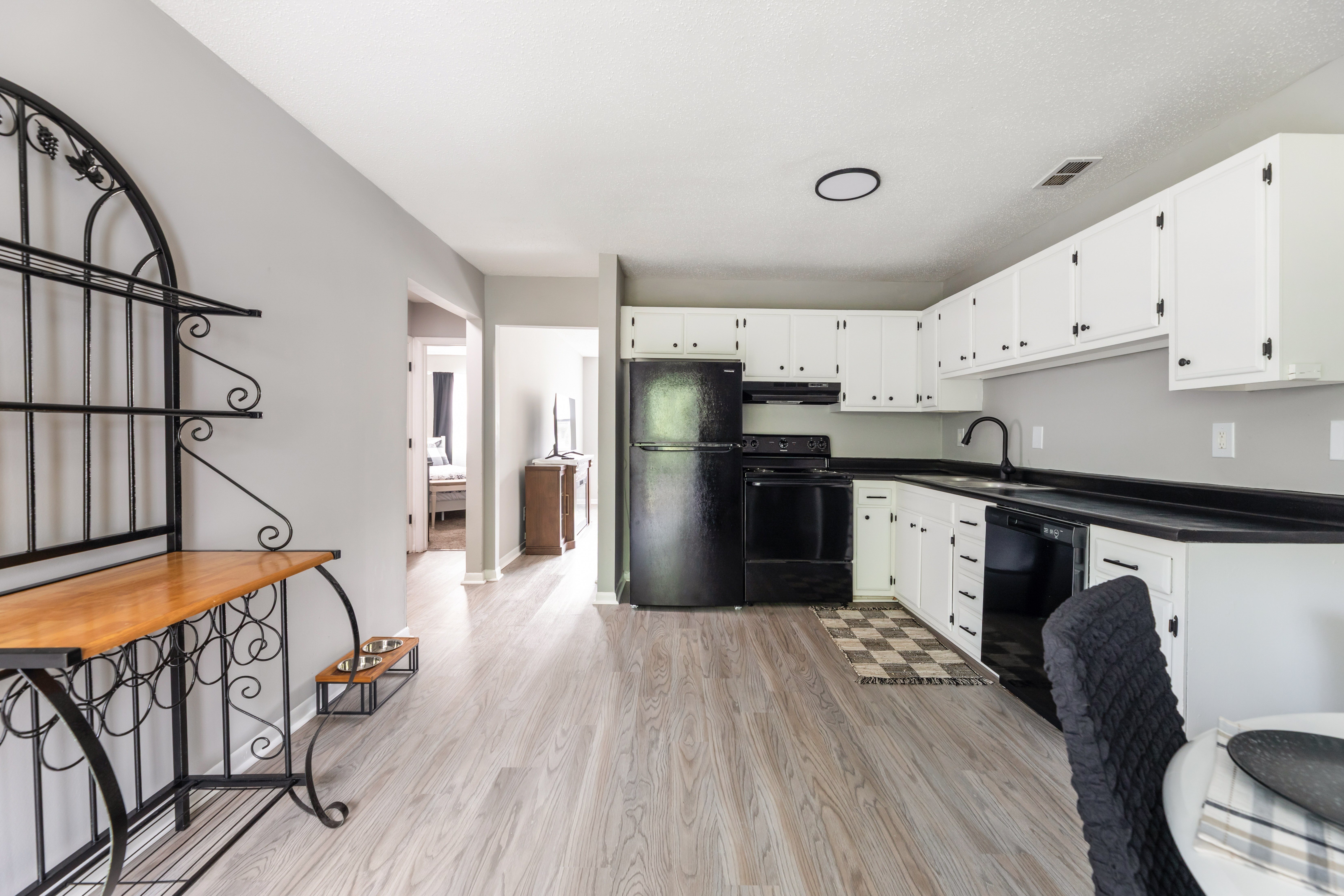 A kitchen with white cabinets and a black oven.at Lauradale, North Carolina